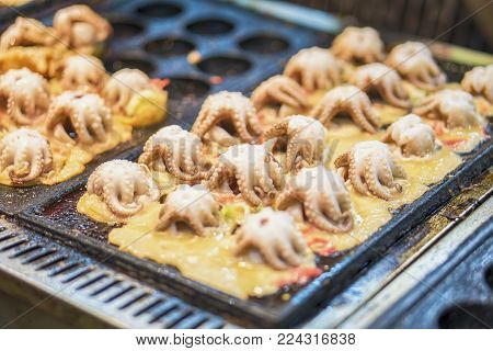 Making Takoyaki by big squid Floating market.