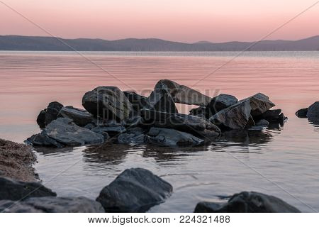 Srones in the water of mountain lake in the morning