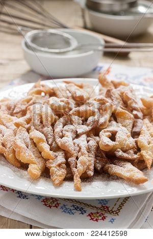 Angel wings biscuits, a traditional European sweet dish for carnival. Rustic style, selective focus.