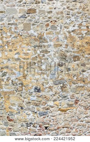 Ancient stone wall of a sea fortress. Beautiful unusual background. Masonry of old stones and bricks.