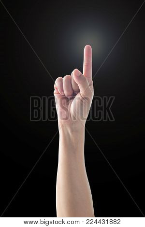 Pointing finger woman's hand with rim light isolated on black background (clipping path) for number one 1, showing direction, go straight forward, good ides