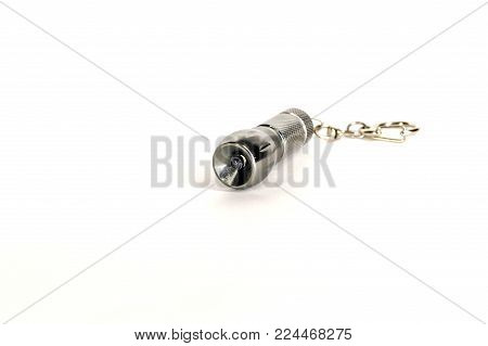 a small led flashlight on white background
