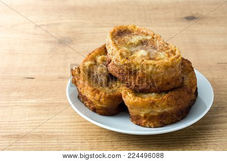 Traditional homemade Spanish torrijas on wooden background. Easter dessert.