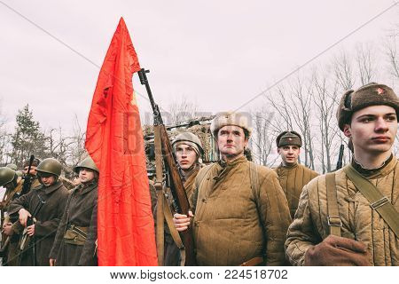 Rogachev, Belarus - February 25, 2017: Re-enactors Dressed As Russian Soviet Infantry Soldiers Of World War II Standing In Row In Forest.