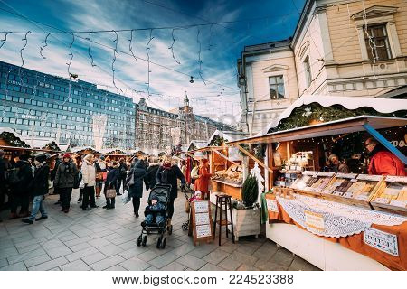 Helsinki, Finland - December 10, 2016: People Walking On Christmas Xmas Market Near Stockmann Department Store On Aleksanterinkatu Street At Winter Sunny Day