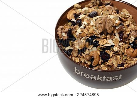 granola with nuts and crandberry close up isolated on white background.
