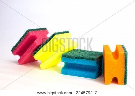multicolored sponges for washing dishes on white background