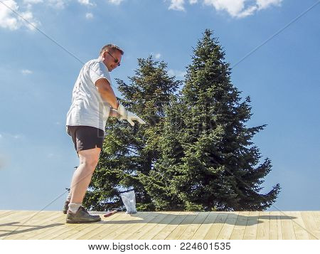 Smiling man working on rooftop in the summer