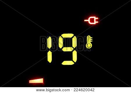 on a black electronic thermometer display -19 degrees Celsius