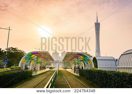 GUANGZHOU, CHINA - JANUARY 3, 2018: Guangzhou city tram station with grass covered rail track  and Canton tower in the background