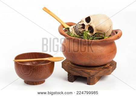 Boiled Skull In Clay Pot With Some Herb On White Background