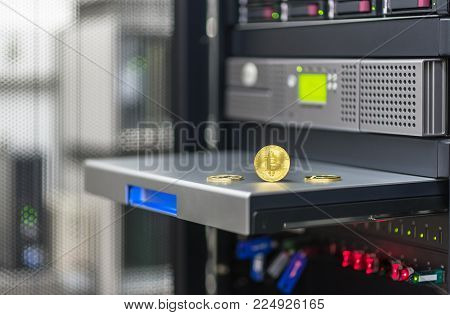 Bitcoin, litecoin ethereum on PC in the server room, golden coins, copy space. Business concept: cryptocurrency fever.