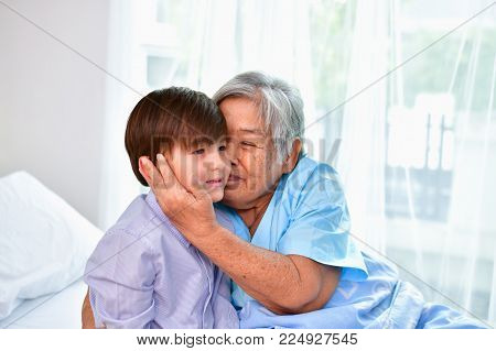 Patient Concept. Grandma's in the hospital. Waiting for someone to visit. Grandchildren visit grandma at the hospital. Grandma is happy to meet grandchildren.