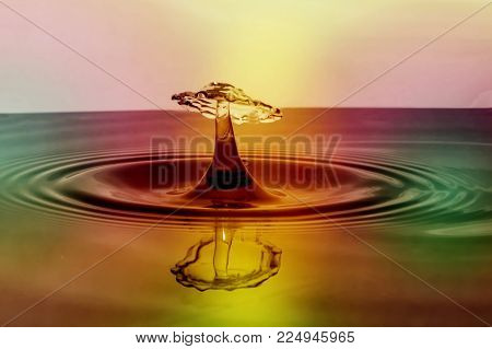 lovely view of drop of water reflected with light colors