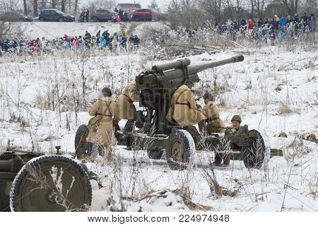 SAINT PETERSBURG, RUSSIA - JANUARY 14, 2018: The female crew of an antiaircraft gun prepares for fight.  Fragment of the military-historical festival 