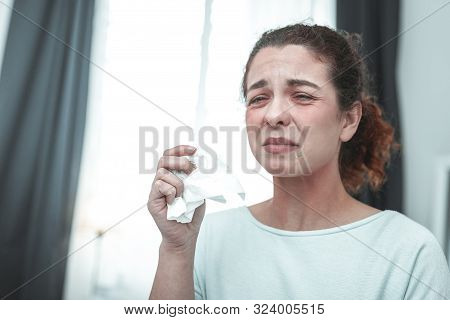 Curly Woman Holding Napkin Sneezing Because Of Allergy