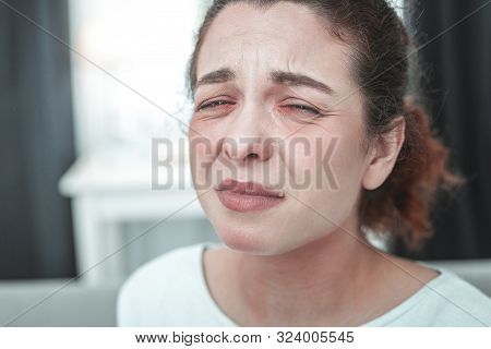 Mature Woman With Facial Wrinkles Crying Having Allergy