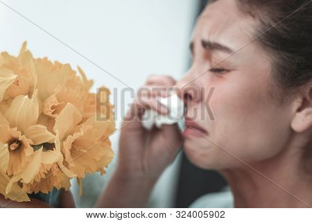 Mature Woman Sneezing While Having Allergy To Flowers