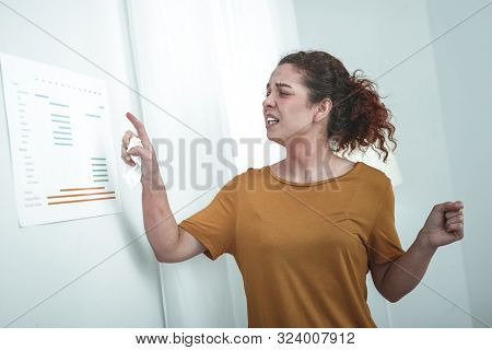 Curly Red-haired Woman Studying Allergens For Her Body