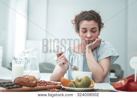 Curly Woman Not Knowing What To Eat While Having Allergy