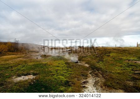 Geyser Natural Miracle. Steam Of Hot Mineral Source In Iceland. Iceland Famous For Geysers. Iceland 