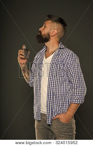 Man Bearded Handsome Hold Bottle Perfume. Fragrance For Brutal Hipster. Fashion And Beauty Treatment