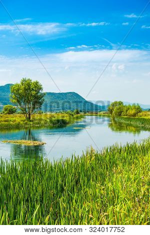 Beautiful Nature Landscape, Gacka River Among Grass Banks, Lika Region Of Croatia
