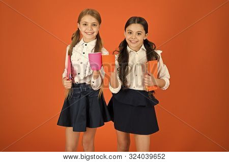 School Mates Relaxing With Drink. Enjoy Being Pupil. Girls Kids School Uniform Orange Background. Sc
