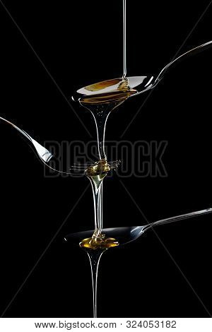 Golden Sweet Honey Dripping From Spoon