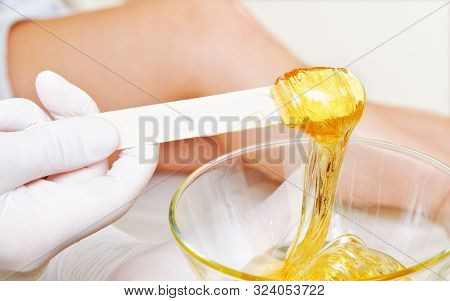Beautician Master Holding Bowl With Hot Wax For Depilation Epilation Hair Removal Procedure And Fema