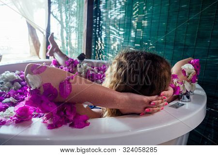Naked Brunette Young Woman Relaxing In Bath With Petals In Tropics. Time For Yourself.romantic 14 Fe