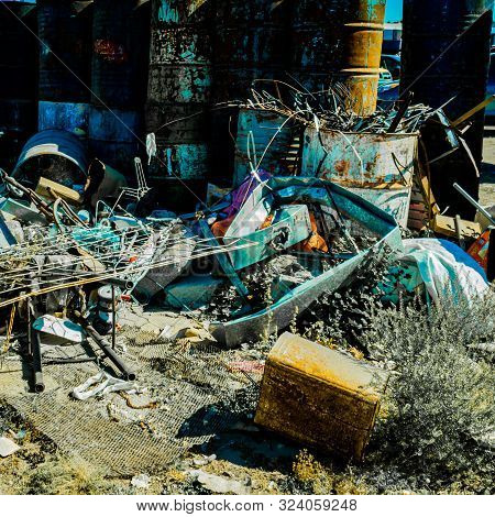 Accumulation Of Garbage Such As Colored Rusty Oil Barrels, Land Full Of Garbage And Waste In Mexico