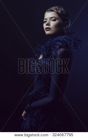 Charming young woman in a luxurious evening dress. Portrait of a beautiful professional dancer. Beauty, fashion.