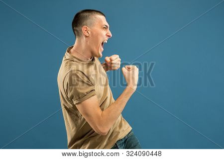 Caucasian Young Mans Half-length Portrait On Blue Studio Background. Beautiful Male Model In Shirt. 