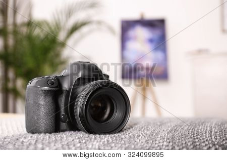 Professional Digital Camera Against Blurred Background. Space For Text
