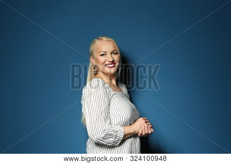 Portrait Of Beautiful Mature Woman On Blue Background