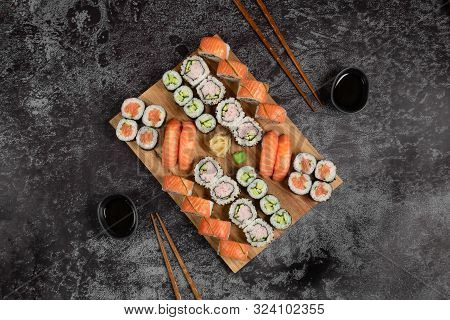 Sushi Set Of Nigiri And Maki Rolls Served On Wooden Board. Japanese Food. Top View