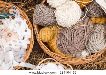 Four Multi-colored Woolen Threads, Rolls Of Beige And Gray Cotton Lace, Wooden Beads In Wicker Ratta