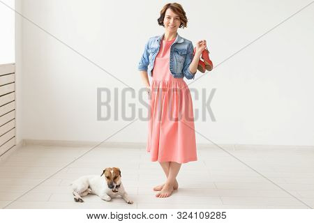 Clothing Designer, People, Pet Concept - Young Woman In Dress And Jeans Jacket With Jack Russell