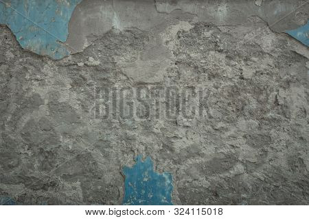 Old Grey Stone Wall With Blue Paint Texture Background. Cracked Aged Dark Surface