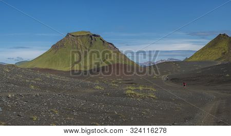 Panoramic Volcanic Landscape Of Green Hattafell And Storasula Mountain With Hikers On Path In Lava D