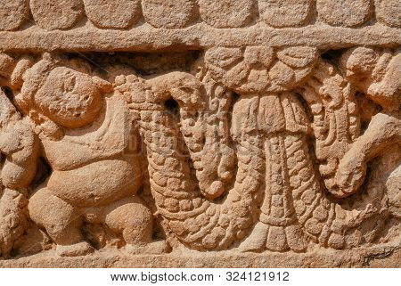Patterns On Stone Relief Of Ansient Indian Temple. Artwork On Facade Of Sstone Structure Of South In