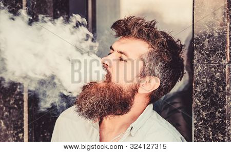 Smoking Electronic Cigarette. Stress Relief Concept. Smoking Device. Man Long Beard Relaxed With Smo