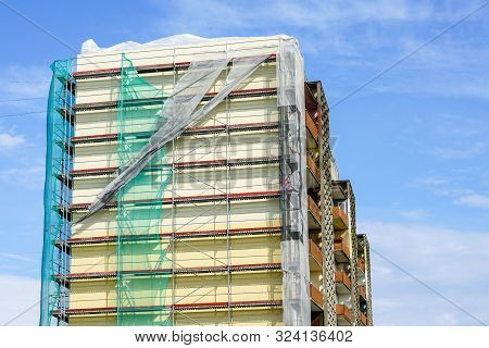 Scaffolding Arround The House To Install Thermal Insulation Of The Apartment Building Facade