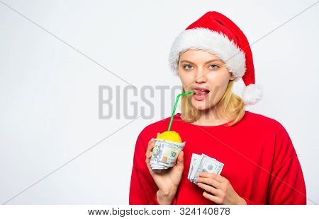 Girl Santa Hat Drink Juice Lemon Wrapped Dollar Banknote. Symbol Of Wealth And Prosperity. Source Of