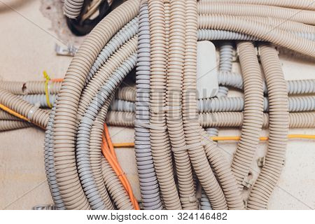 Rows And Loops Of Different Coloured And Confusing Wires, Cables, Pipes And Looms, Which Form Part O