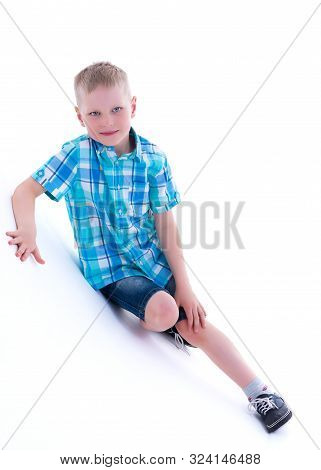 Cute Little Boy Studio Portrait On White Cyclorama. The Concept Of A Happy Childhood. Isolated On Wh