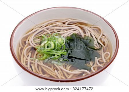 Japanese Kake Soba Noodles In A Ceramic Bowl On White Background