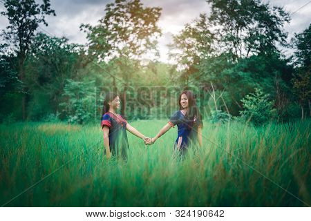 Portrait Of Young Girls Enjoy Playing In The Mist Of Foresst Outdoor At Countryside Of Thailand
