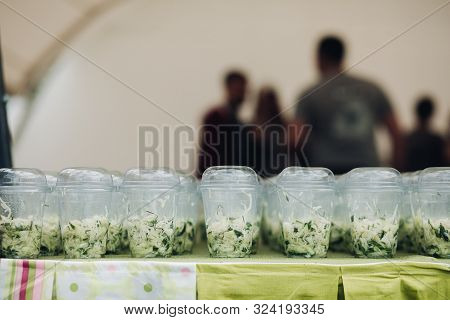 Organic Veggies In Cups To Go.close-up Of Loads Of Plastic Cups Filled With Chopped Vegetables And S
